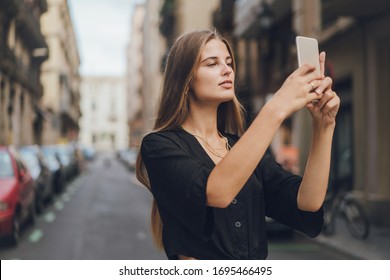 Girl is shooting a story for the Instagram, she uses her phone for publishing it, beautiful and attractive stories are important for success in blogging.