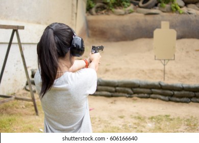 Girl Shooting Target With Gun