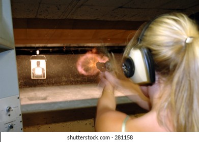 Girl shoots an gun range.