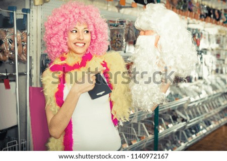 Girl is shopping in festive accessories shop.