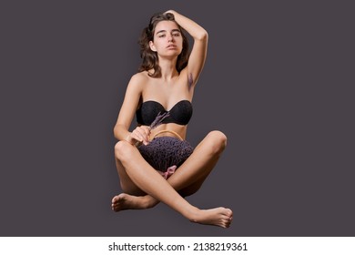 Girl In Shorts Sticks Out Them Lavender Like Pubic Hair. Symbol Stubble And Problems With Home Depilation. Razor Near Excess Hair. Body Positivity And Body Hair Problems. On A Black Background