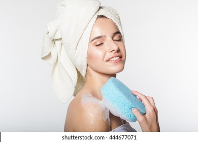 Girl in shower holding wisp with foam