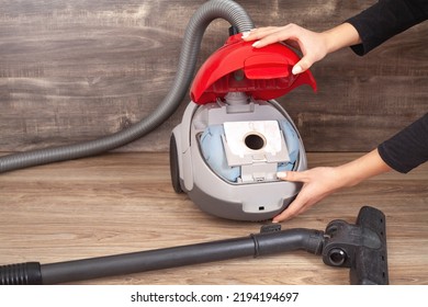 Girl Showing Dust Bag In A Vacuum Cleaner.