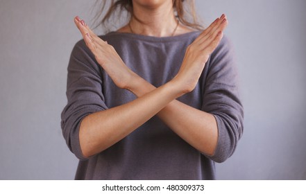 Girl Shows No Hands. Isolated On Gray Background.