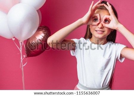 girl shows shows two fingers, portrait of teen girl on pink background