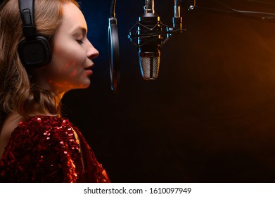 Girl singing into a microphone. Love for music. Screensaver for learning music or vocals.