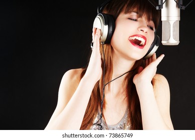 Girl Singing To The Microphone In A Studio