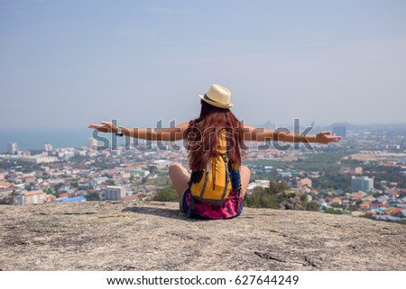 Girl sits back on hill