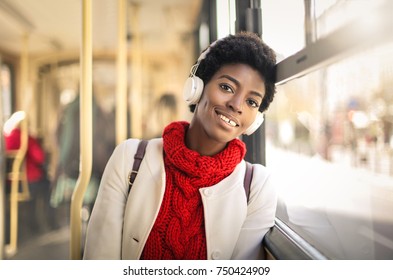 Girl sitting in a bus and listening music - Powered by Shutterstock