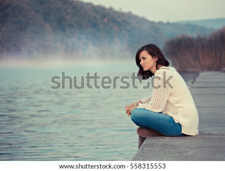 Girl  sitting by lake