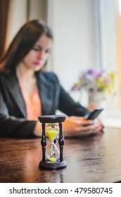 girl sitting in a cafe , in a business suit . the girl is very sexy and beautiful . on the table an hourglass , a book and a tablet ,coffee - Shutterstock ID 479580745