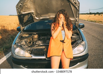 Girl Sitting In Her Car Worried About Her Car Breaking Down And Having A Problem.