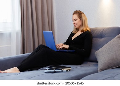 The Girl Is Sitting At Home On The Couch And Working At The Computer. Online Training And Remote Access Work, Coach. Remote Work From Home, Quarantine.