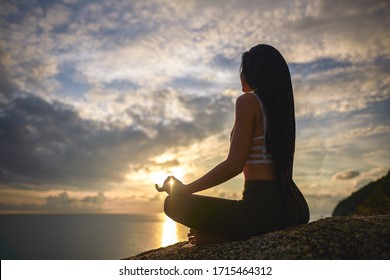          girl sitting in a meditation pose on nature background                       - Shutterstock ID 1715464312