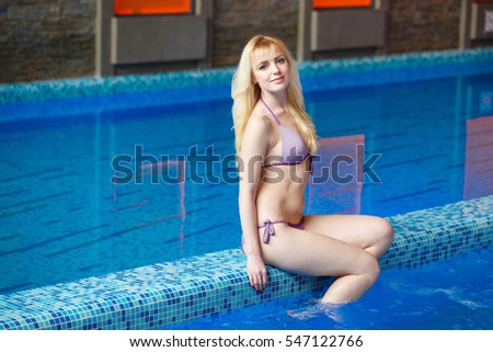 Girl sitting near the pool.