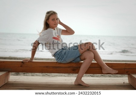 Similar – Young, long-legged woman sitting on the Baltic Sea beach