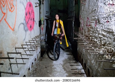 girl sitting on the bike in an abandoned room