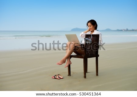 Girl sitting on chair working with laptop 