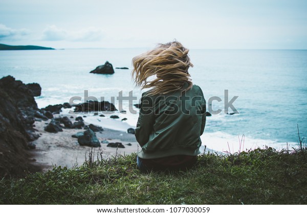 Girl Sitting On Cliff Overlooking Ocean Stock Photo (Edit Now) 1077030059