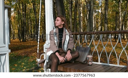 Girl sitting on a park bench.