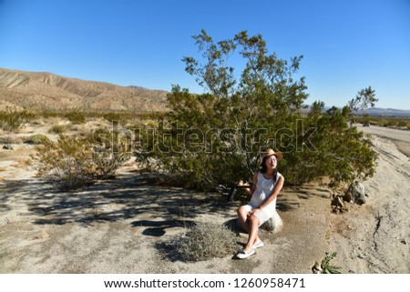 Girl sitting on the roadside
