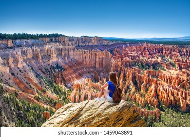 Girl sitting on the top of the mountain looking at beautiful view. Woman relaxing on the rock on summer vacation hiking trip. Inspiration Point. Bryce Canyon National Park,Utah, USA - Powered by Shutterstock