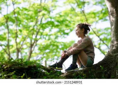 Girl Sitting In The Shade Of A Tree