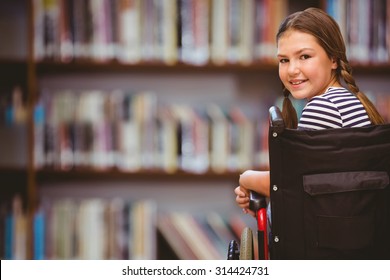 Girl sitting in wheelchair in school against library shelf - Powered by Shutterstock