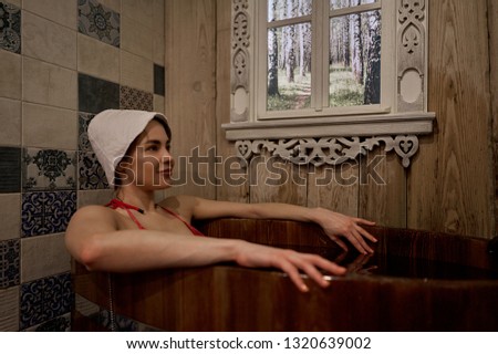 girl sitting in a wooden barrel