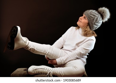 Girl With Skates On Her Feet. Dressed In All White.Figure Skater.