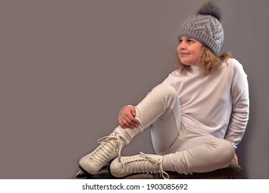 Girl With Skates On Her Feet. Dressed In All White.Figure Skater.