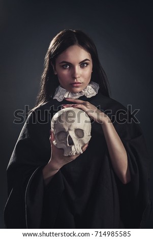 a girl with a skull in her hands