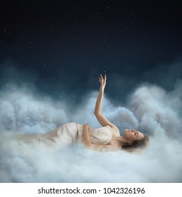 Girl Sleeping In The Clouds. Touch The Stars. Dreaming Concept