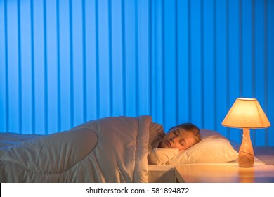 The Girl Sleeping On The Bed. Evening Night Time