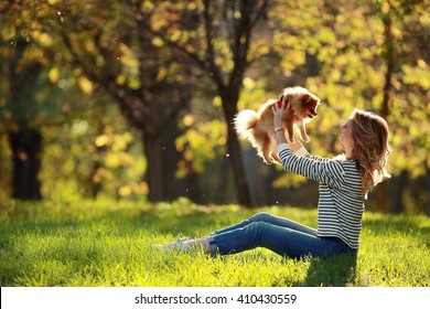 Girl With A Small Dog In The Park Spitz