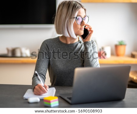 A girl smartworking from her home. The secretary working in her office. Beautiful women drink a coffee and works at the computer or laptop.
