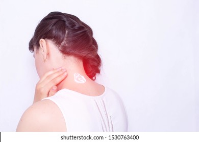 The Girl Smears Her Neck With A Healing Cream To Relieve Muscle Tension And Pain. Treatment Of Cervical Spinal Diseases, Copy Space