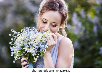 Girl Smelling A Lily Of The Valley