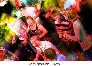 Girl Smiling At The Camera On A Busy Dance Floor In A Discotheque