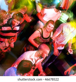 Girl Smiling At The Camera On A Busy Dance Floor In A Discotheque