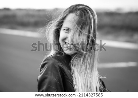 Similar – Happy young woman with moving hair in urban background