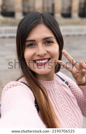 girl smiling taking a selfie in the city of bogota in colombia