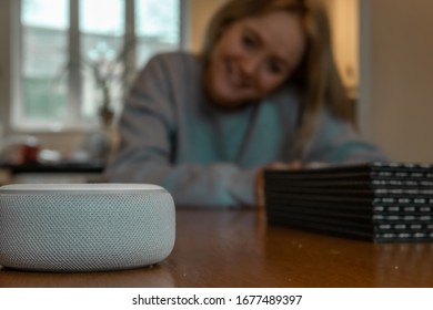 Girl smiling and talking to an Alexa in mosterton on March 2019