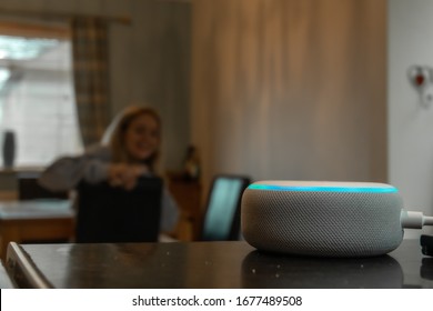Girl smiling and talking to an Alexa in mosterton on March 2020