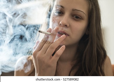 Girl Smoke Cigarette In The House. Close Up Smoker.