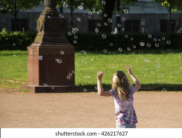 Girl with soap bubbles. Chasing dreams. 