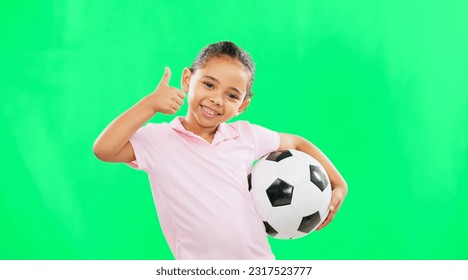 Girl, soccer ball and thumbs up in green screen studio with smile, face and happiness in sport mockup. Young female child, football mock up and happy for kids sport agreement, portrait and training - Powered by Shutterstock