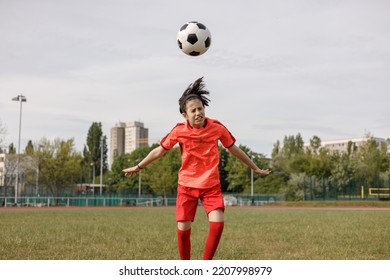 A Girl Soccer Player Heading The Ball