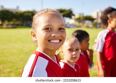 Girl soccer player, portrait and field for training, teamwork and group diversity with smile. Young female kids, football group and happy for team building, learning and development with excited face - Powered by Shutterstock