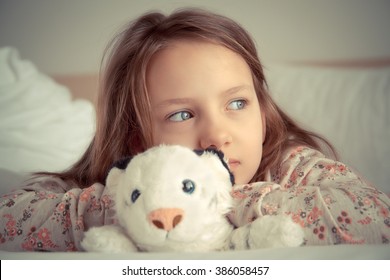 Girl With Soft Toy In Bed